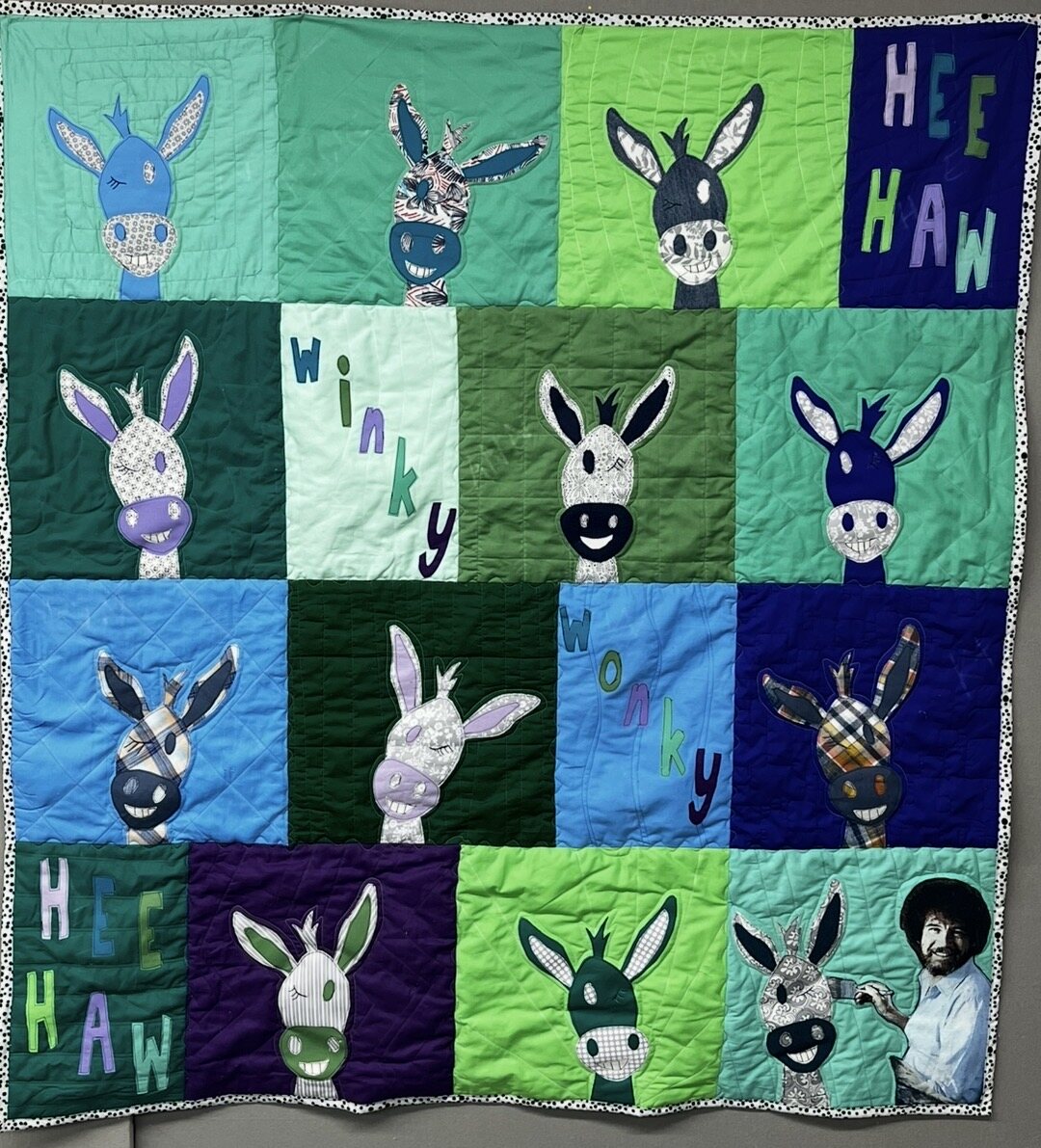 Colorful appliqué quilt featuring individually designed donkeys